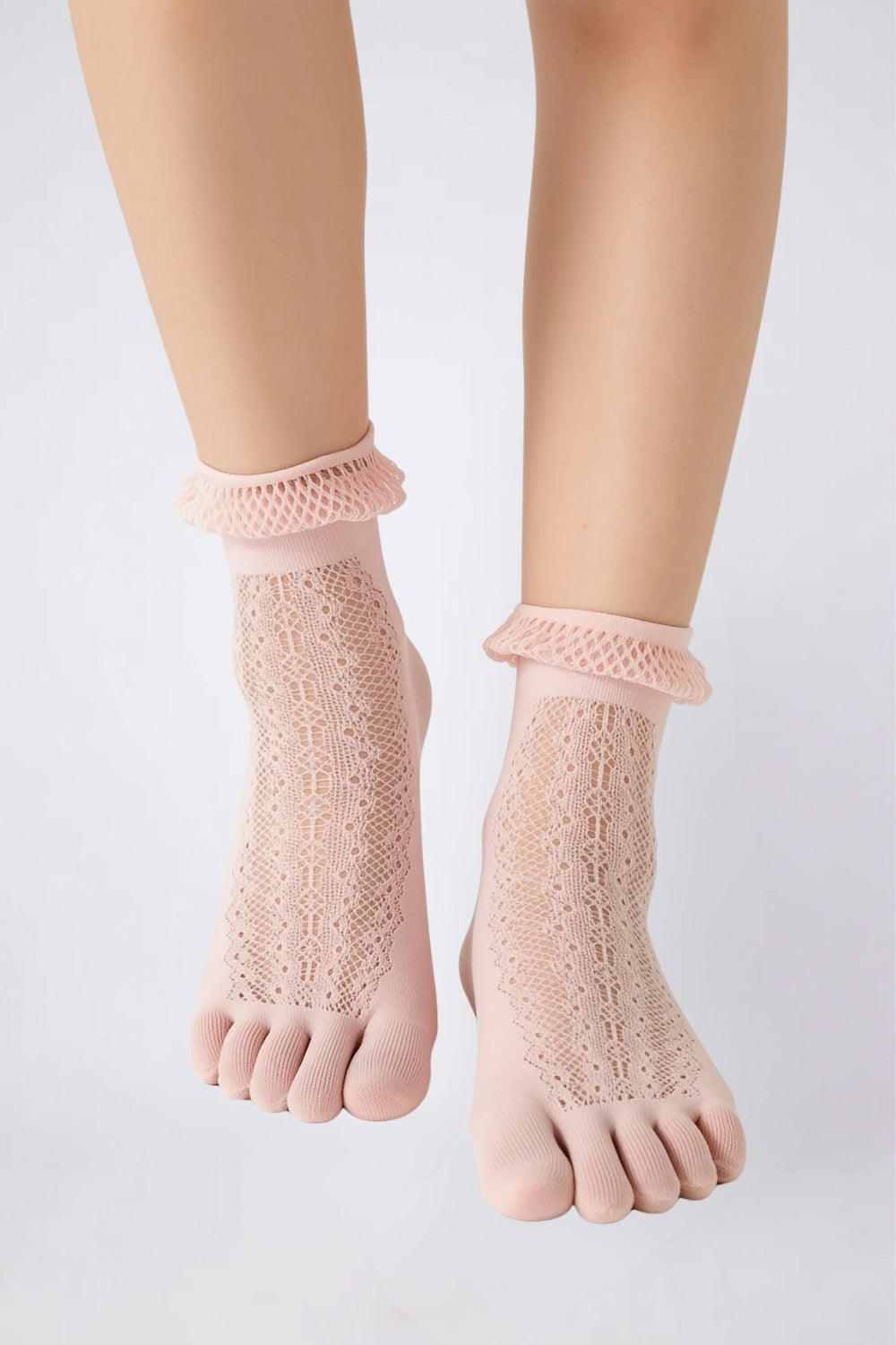 Model wearing sheer lace five-toe stockings in pink