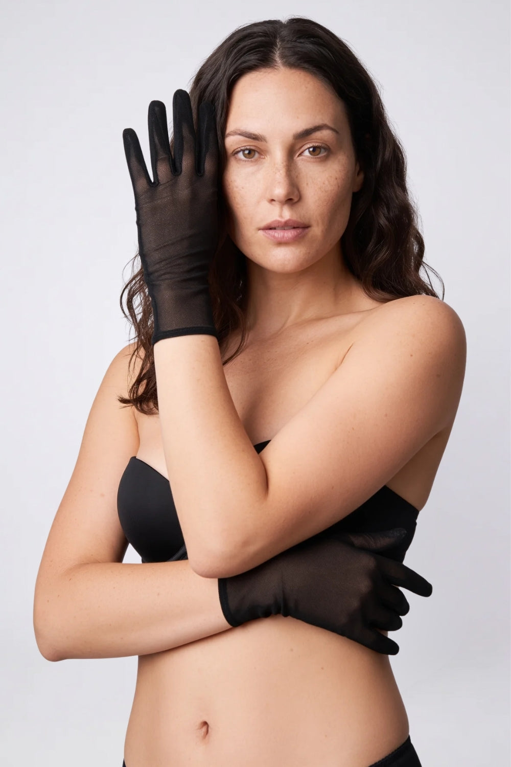 Model wearing sheer mesh wrist gloves in black