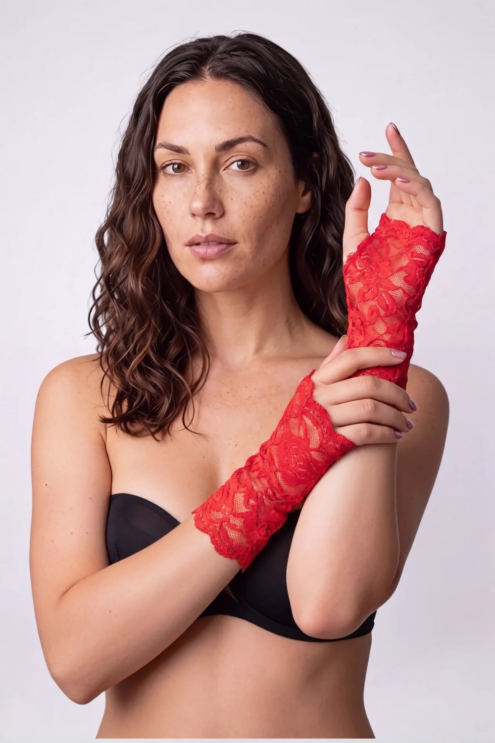 Model wearing sheer rose lace fingerless gloves in red, alternate view