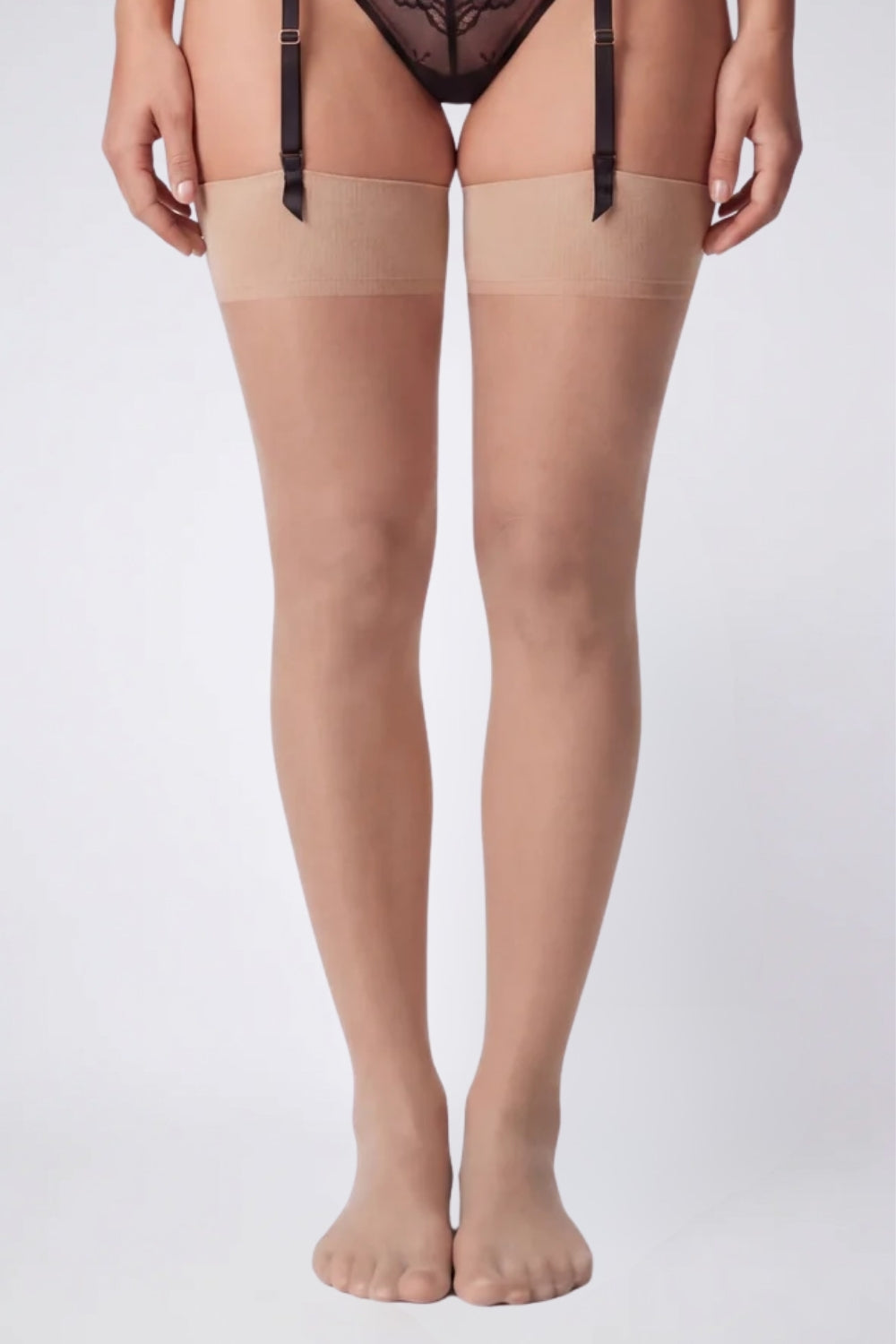 Model wearing sheer silky finish thigh-high stockings in nude