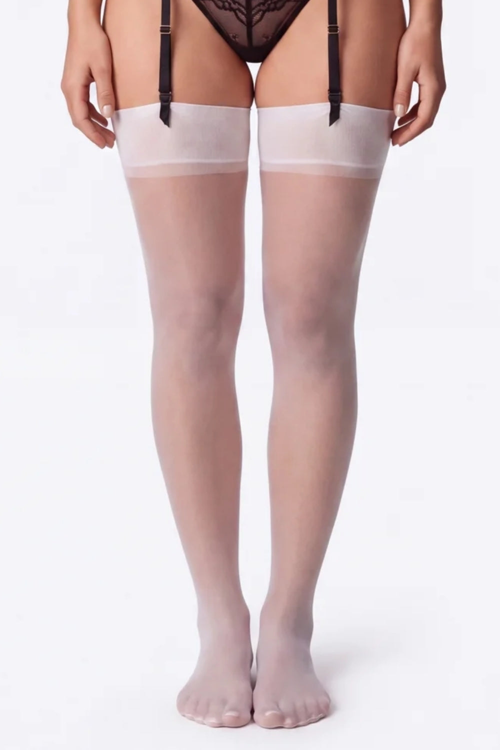Model wearing sheer silky finish thigh-high stockings in white