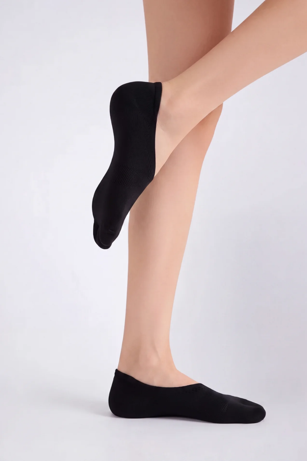 Model wearing split-toe no-show stockings in black, alternate view