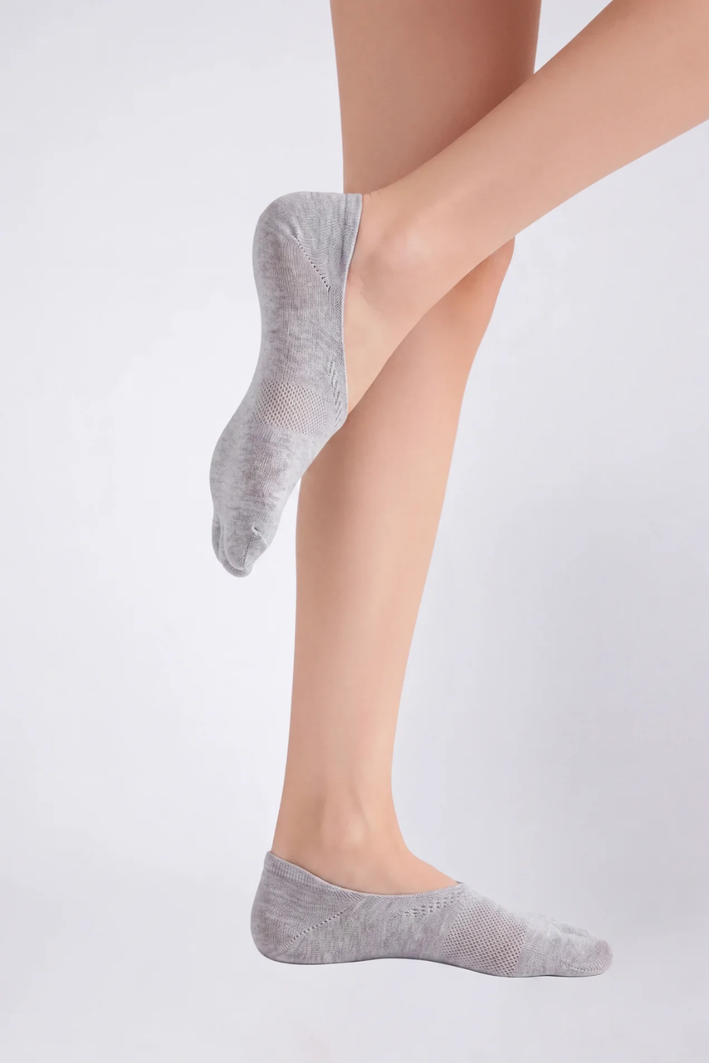 Model wearing split-toe no-show stockings in grey, alternate view
