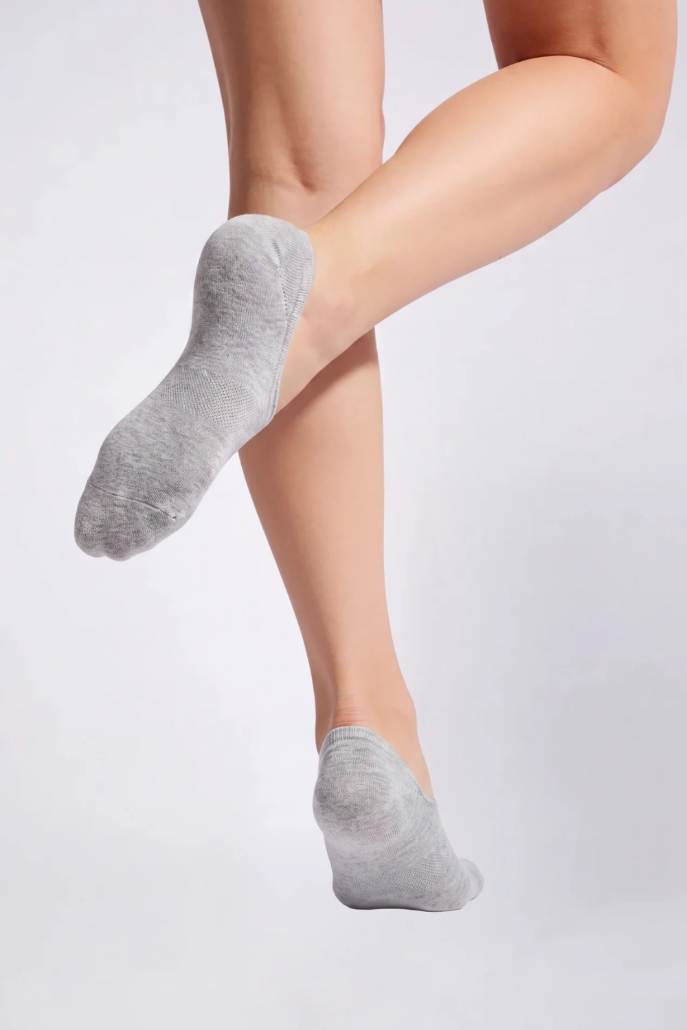Model wearing split-toe no-show stockings in grey, alternate view