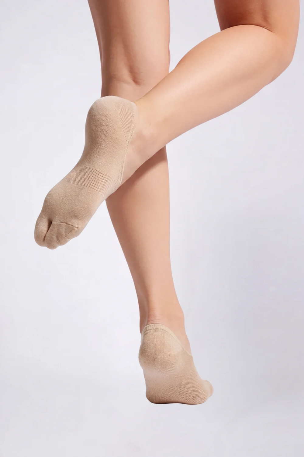 Model wearing split-toe no-show stockings in nude, alternate view