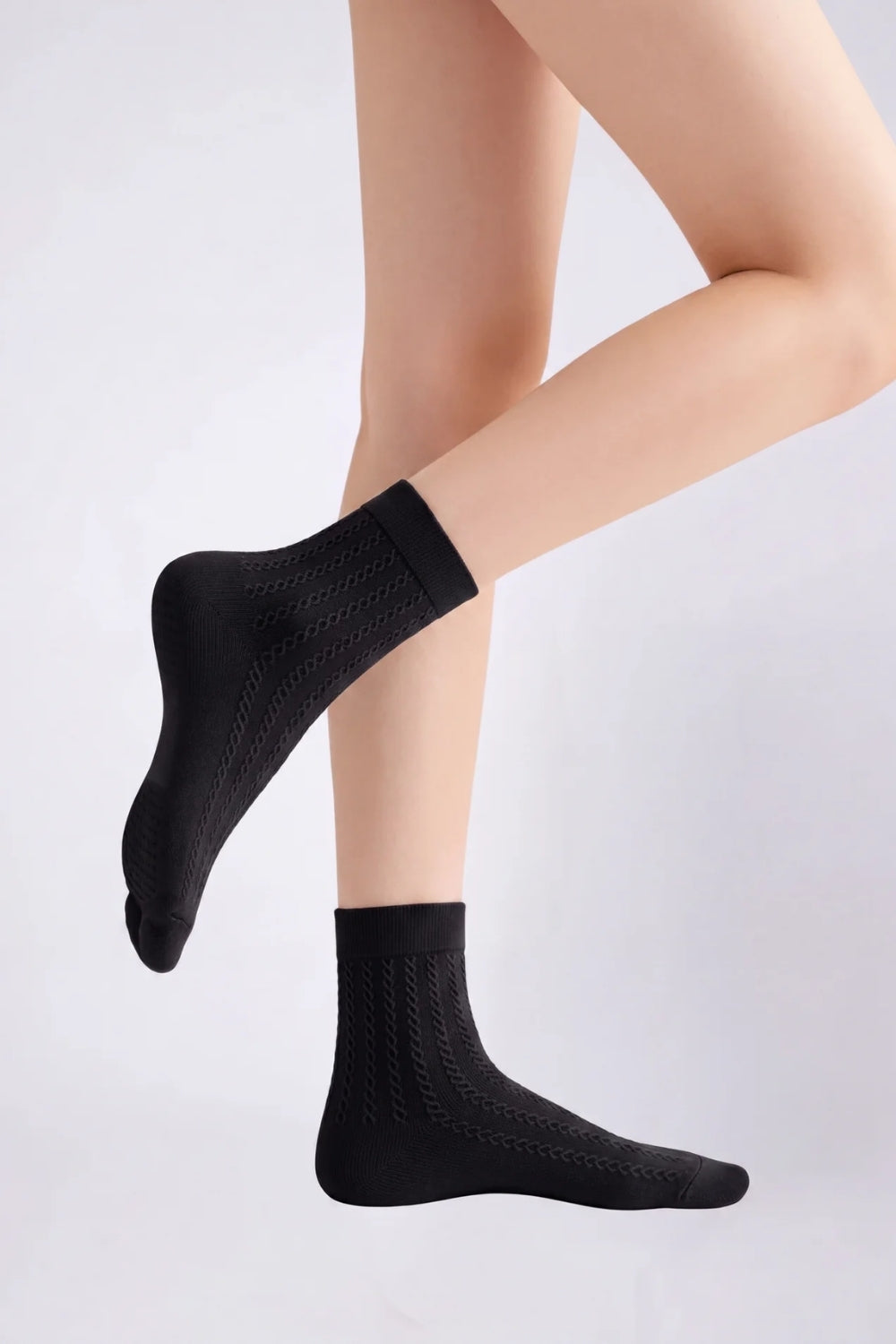 Model wearing textured ultra-thin ankle stockings in black, alternate view