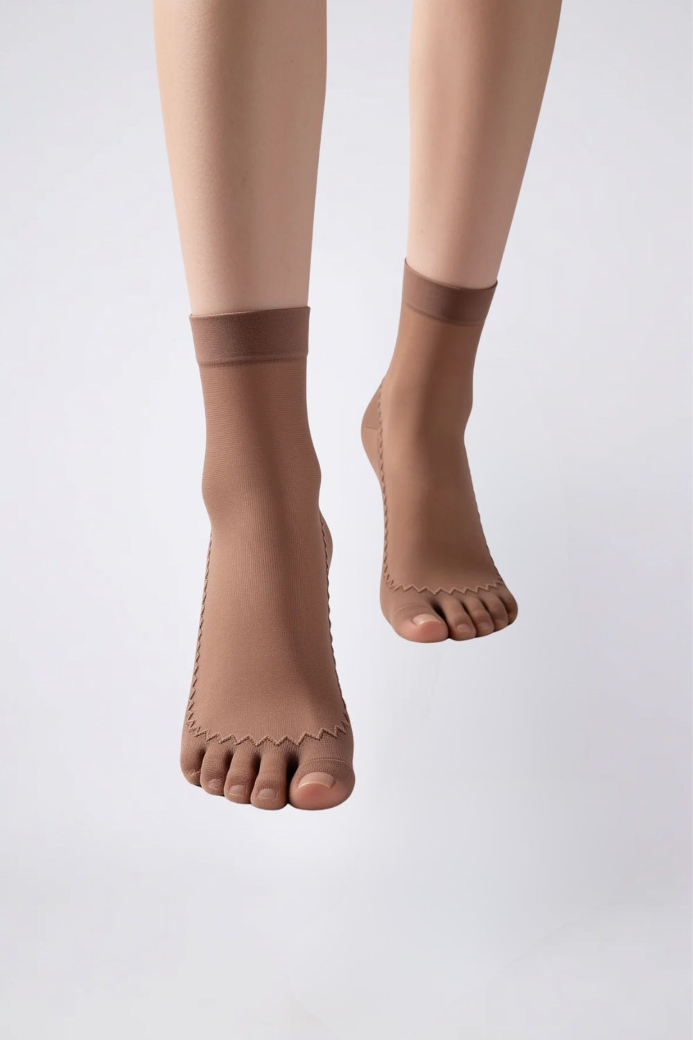 Model wearing ultra-thin sheer cotton sole stockings in brown