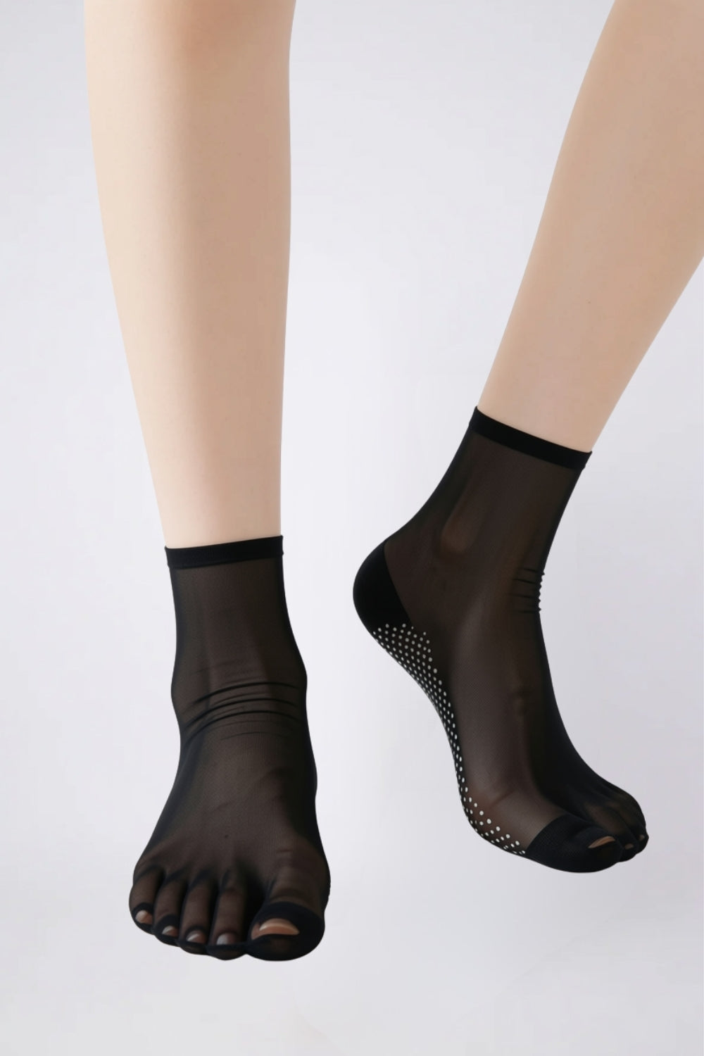 Model wearing ultra-thin sheer grip sole stockings in black