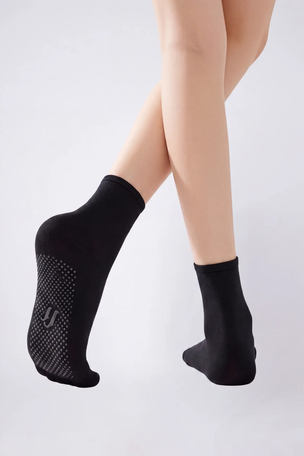 Model wearing ultra-thin sheer grip sole stockings in black, alternate view