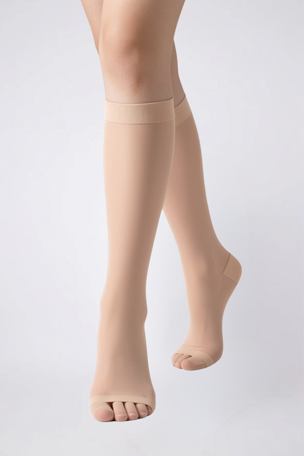 Model wearing ultra-thin sheer knee high stockings in nude